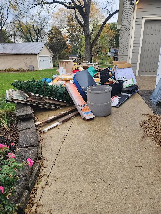 Dumpster being loaded with debris for Estate Cleanout Dumpster Rental in Rahway
